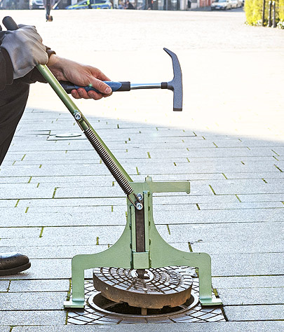 Cover lifter and cover hammer for easy opening of street caps for gas and water supply.